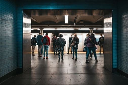 A group of people walking in a subway

AI-generated content may be incorrect.